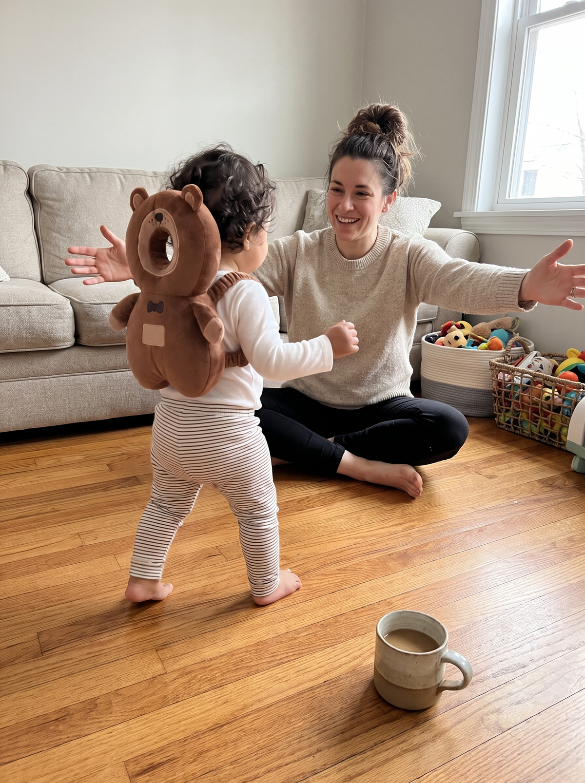 Toddler in the bear head cushion backpack walking toward her mum